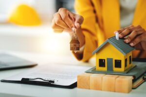 A hand holding up a set of house keys