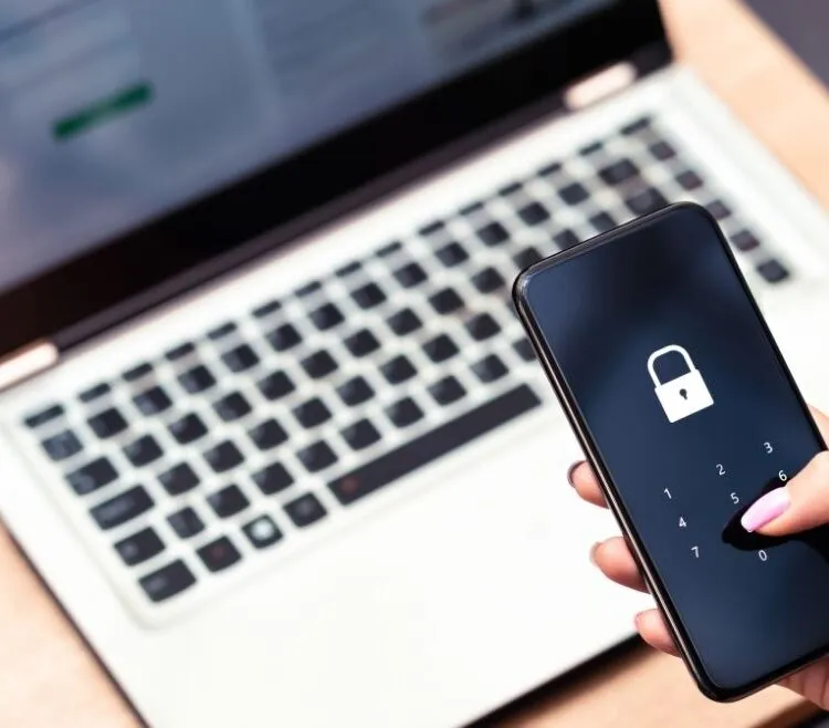 a laptop and phone screen showing a lock icon