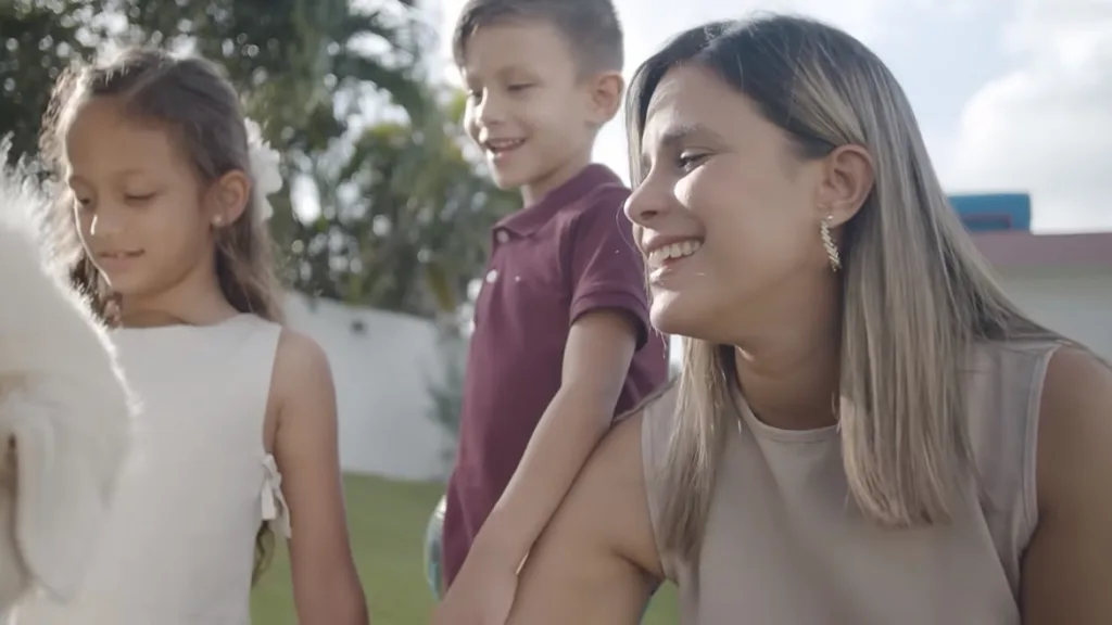 Image of woman playing with two children